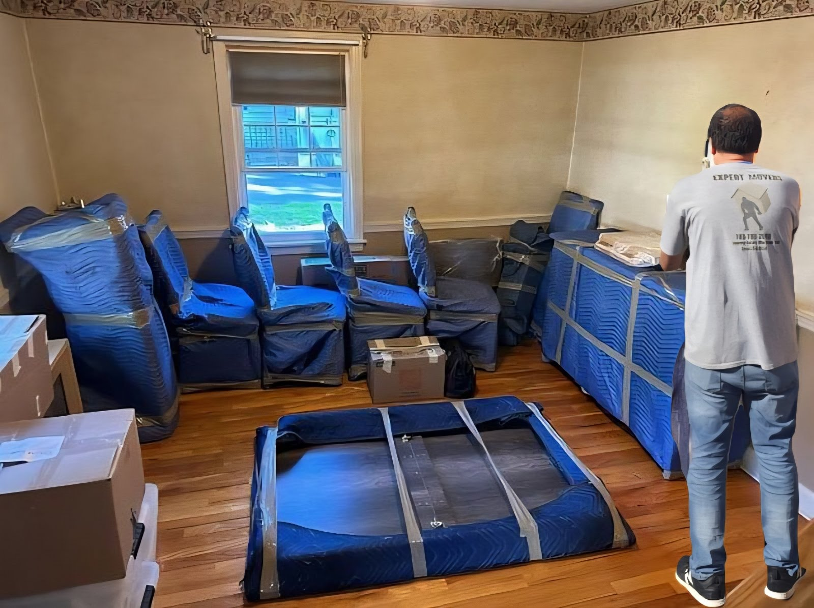 Expert Movers carefully wrapping furniture for protection